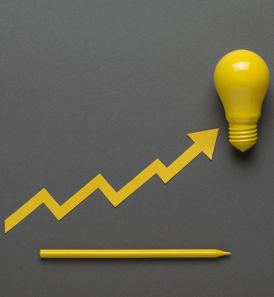 Yellow light bulb and arrow symbolising growth and steady progress, reflecting Carvina Capital’s disciplined investment approach.