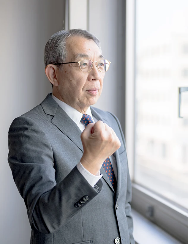 Portfolio manager gazing out, fist clenched—research-driven resolve to compound capital across market cycles.